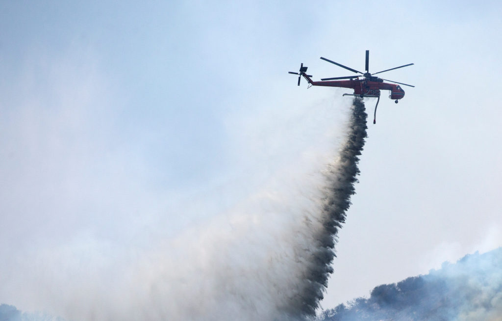 Source-feed image associated with Helicopter battling Utah wildfire crashes with no word on the 2 people aboard