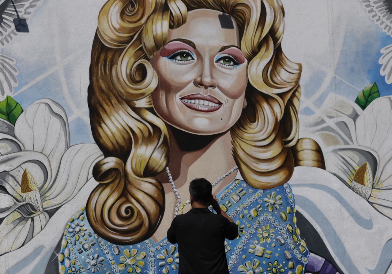 Source-feed image associated with Dolly Parton’s music, books and theme park see spikes in interest following her death