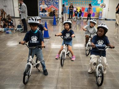 Source-feed image associated with A childhood rite moves indoors as kindergartners learn to ride bikes in school gyms