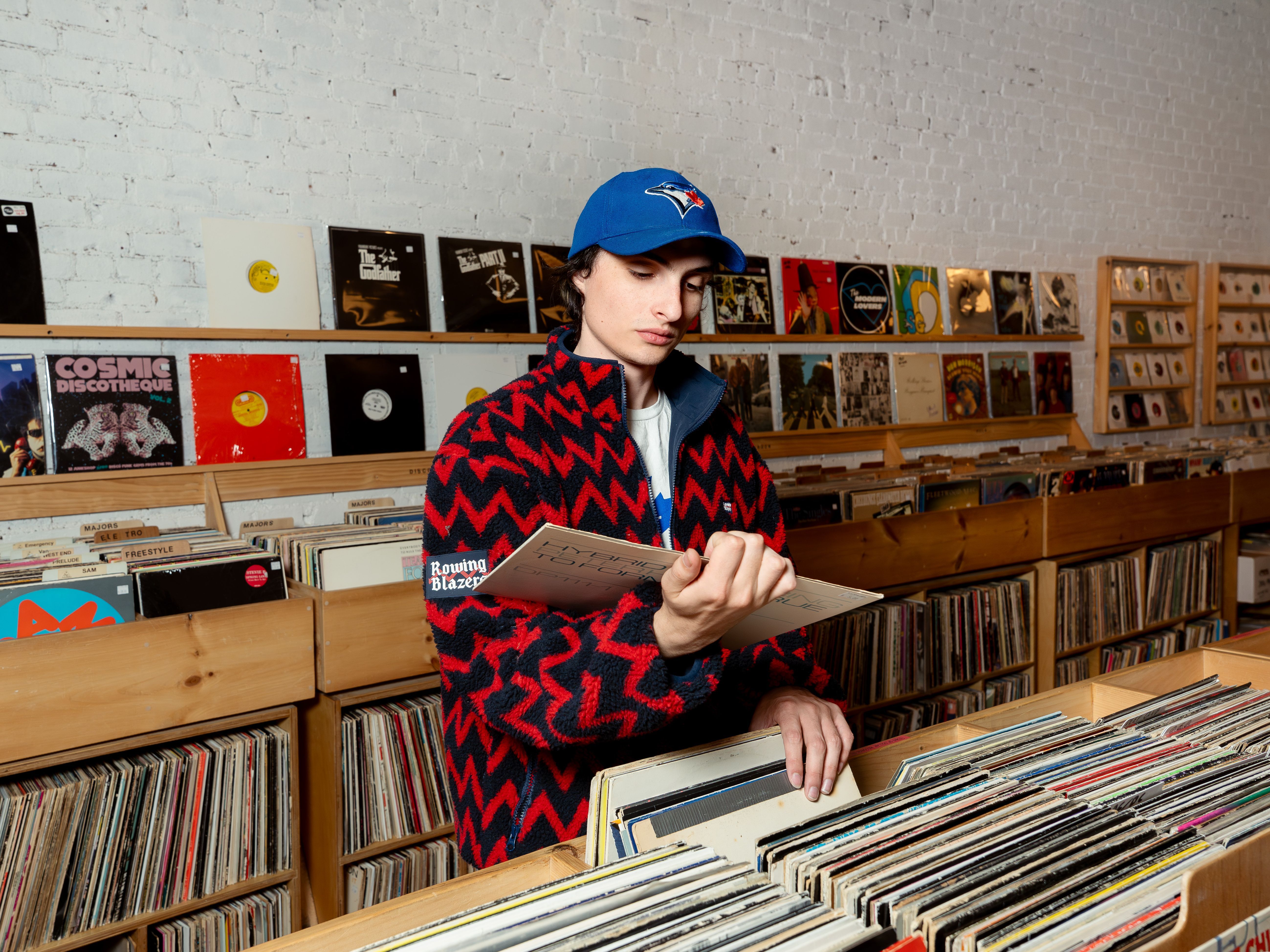 Source-feed image associated with Ahead of His New Album, Finn Wolfhard Goes Record Shopping With Vogue