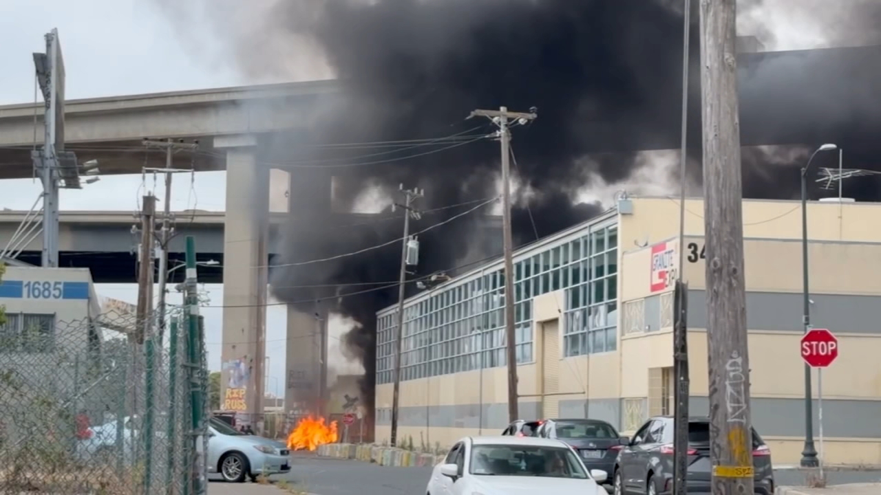 Source-feed image associated with Crews battle fire near I-580 in Oakland