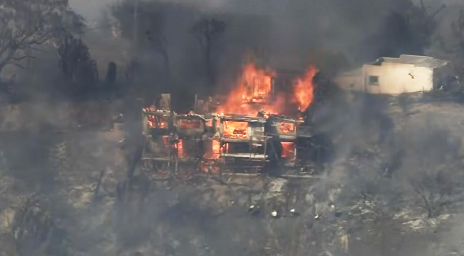 Source-feed image associated with 2 homes destroyed, another damaged in Palos fire in La Habra Heights