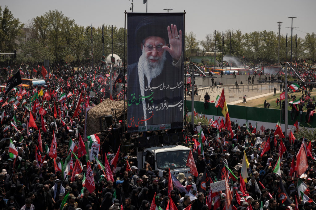 Source-feed image associated with News Wrap: Funeral held for Iran's late Supreme Leader
