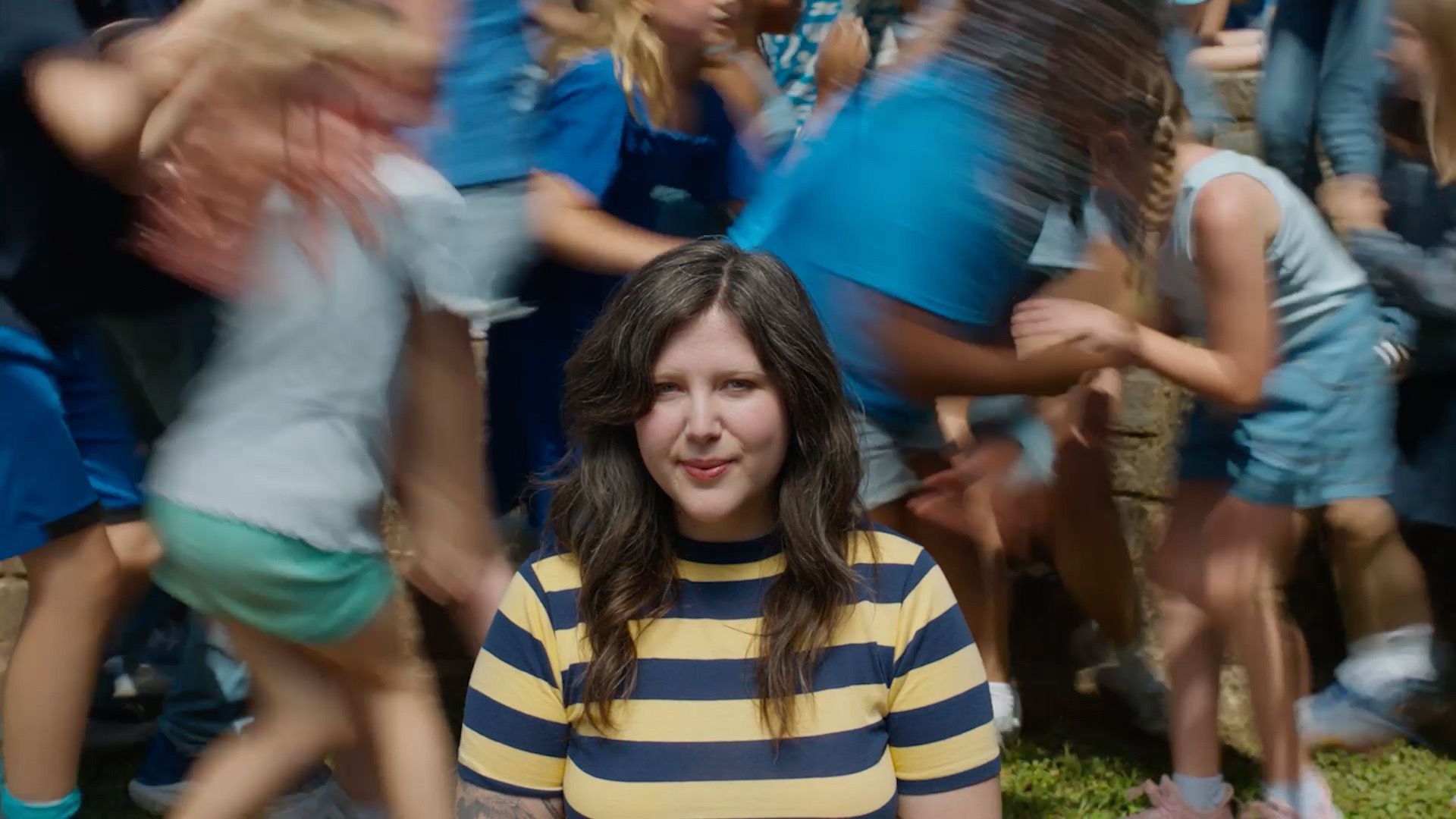 Source-feed image associated with Watch Lucy Dacus and Her Dad Wander a Cemetery in “Planting Tomatoes” Video