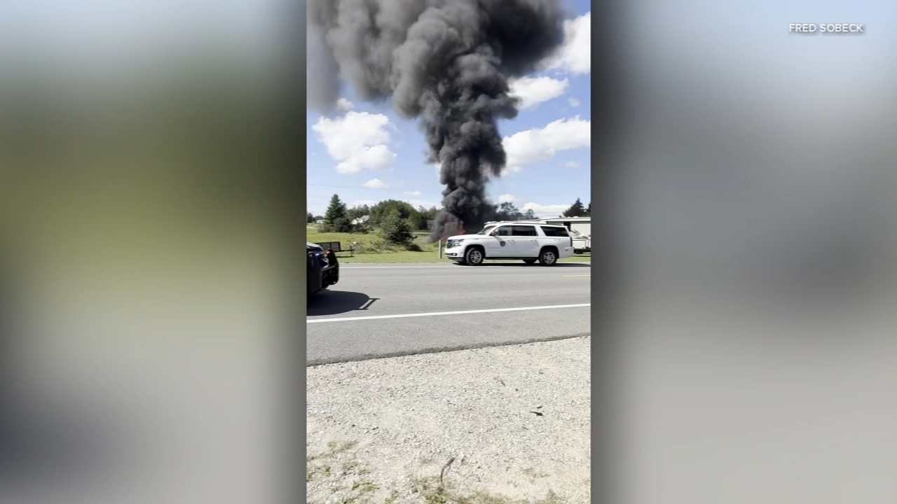 Source-feed image associated with F-16 fighter jet crashes during training exercise in northern Michigan; pilot ejects safely