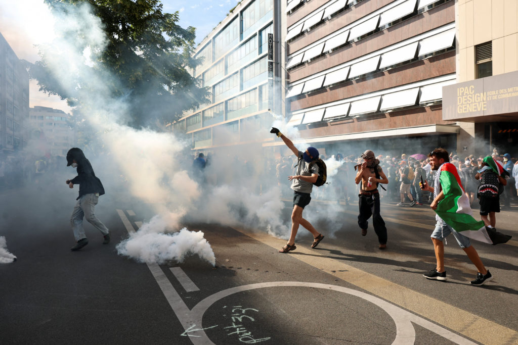 Source-feed image associated with Protesters in Geneva clash with police ahead of the G7 summit in nearby France