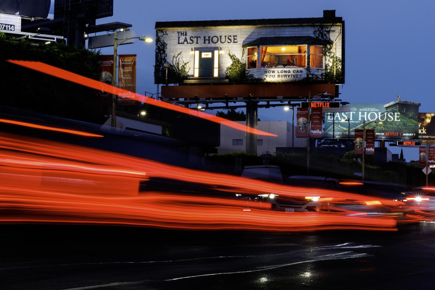 Source-feed image associated with WeHo's newest resident enjoys A/C, Sunset Strip views ... from inside a billboard. Why he's there