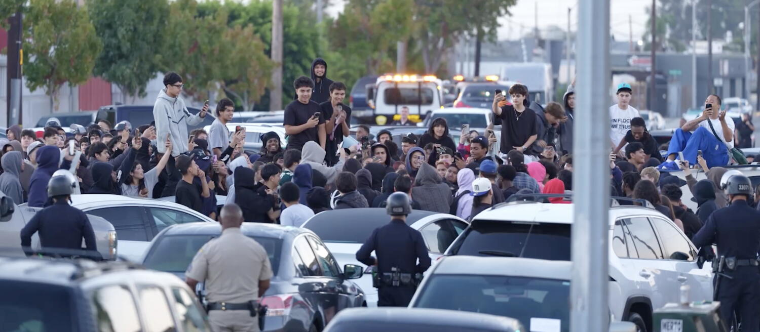 Source-feed image associated with LAPD arrest 69 people, impound 200 cars at illegal street gathering in Harbor Gateway