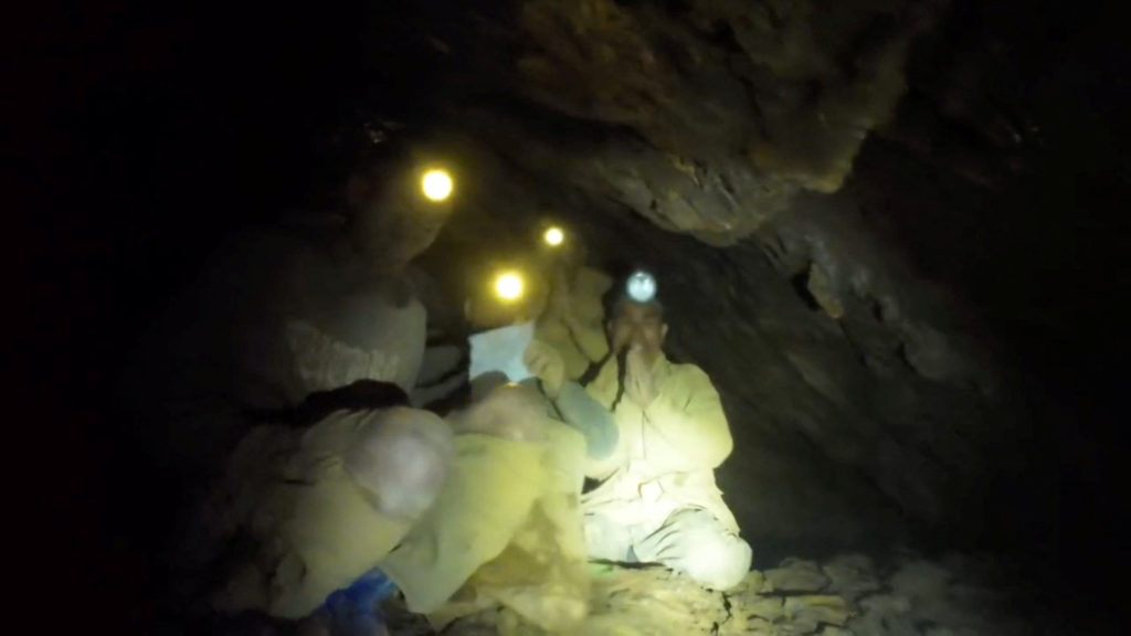 Source-feed image associated with Rescuers evacuate the first of 5 villagers found trapped in a cave in Laos; 2 still missing