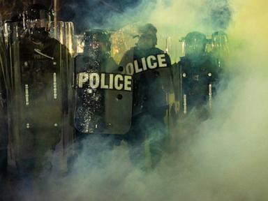 Source-feed image associated with New Jersey police sergeant charged with stealing journalist's camera bag at immigration protest
