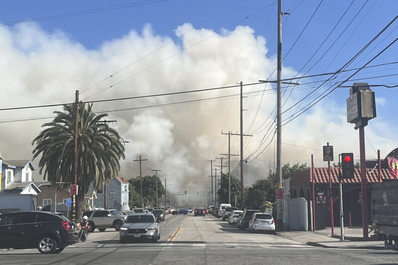 Source-feed image associated with Boyle Heights warehouse fire flares up Friday due to wind