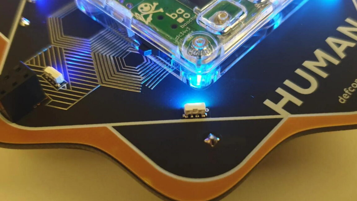 Source-feed image associated with Defcon's new badge is a security key you can see inside