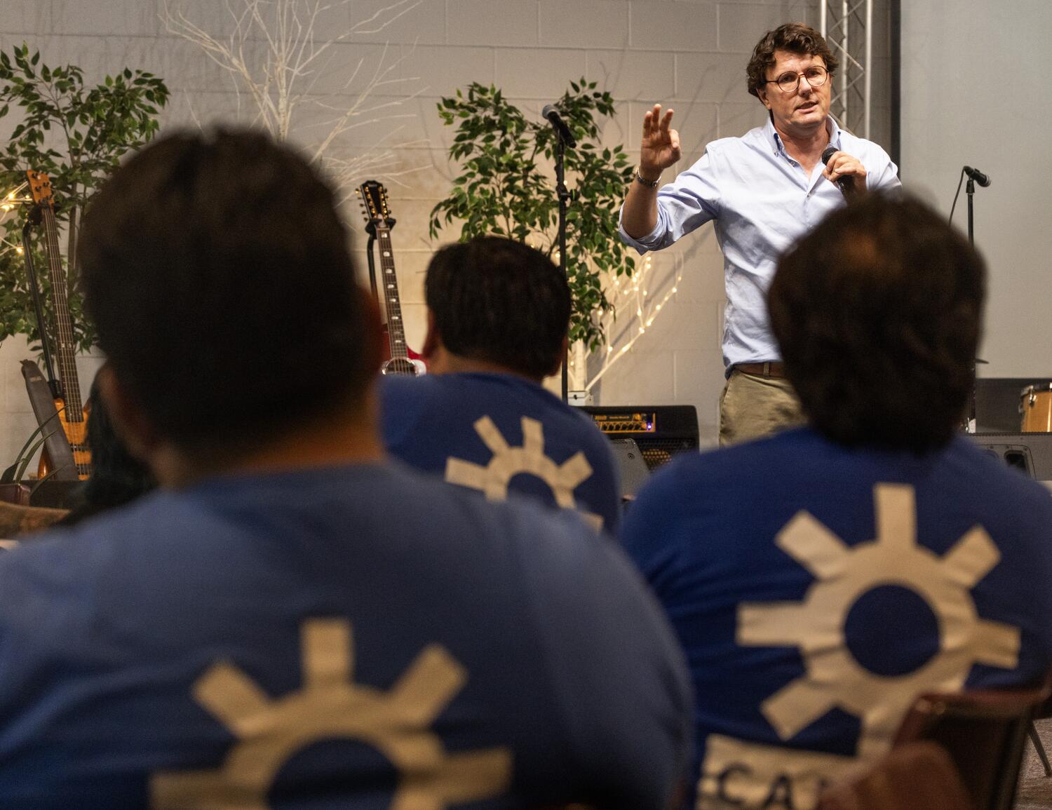 Source-feed image associated with Day laborers come together at a convention to process a year and a half of ICE raids