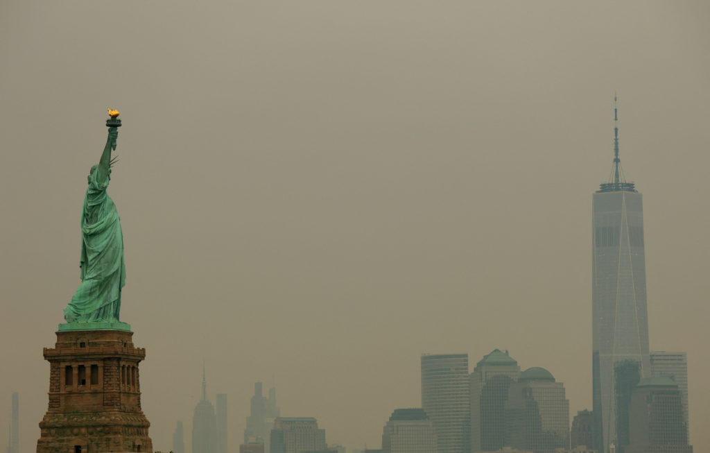 Source-feed image associated with As wildfire smoke makes air unhealthy from Midwest to East Coast, officials say stay inside