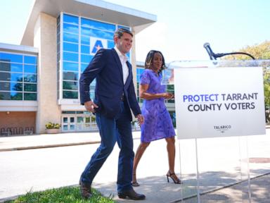 Source-feed image associated with Plan to cut number of polling sites in a major Texas county draws protests as Senate race looms