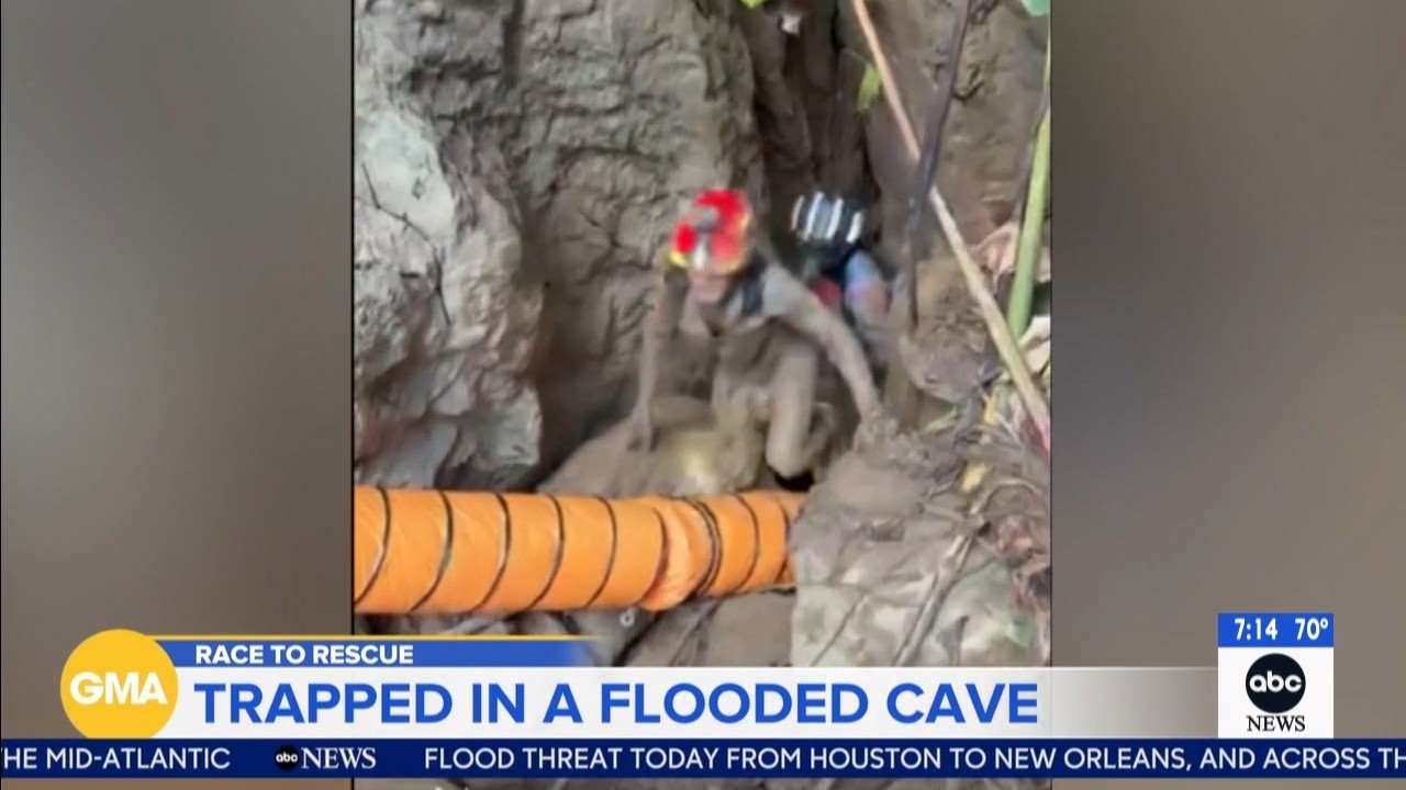 Source-feed image associated with Rescuers evacuate the first of 5 villagers found trapped in a cave in Laos; 2 still missing
