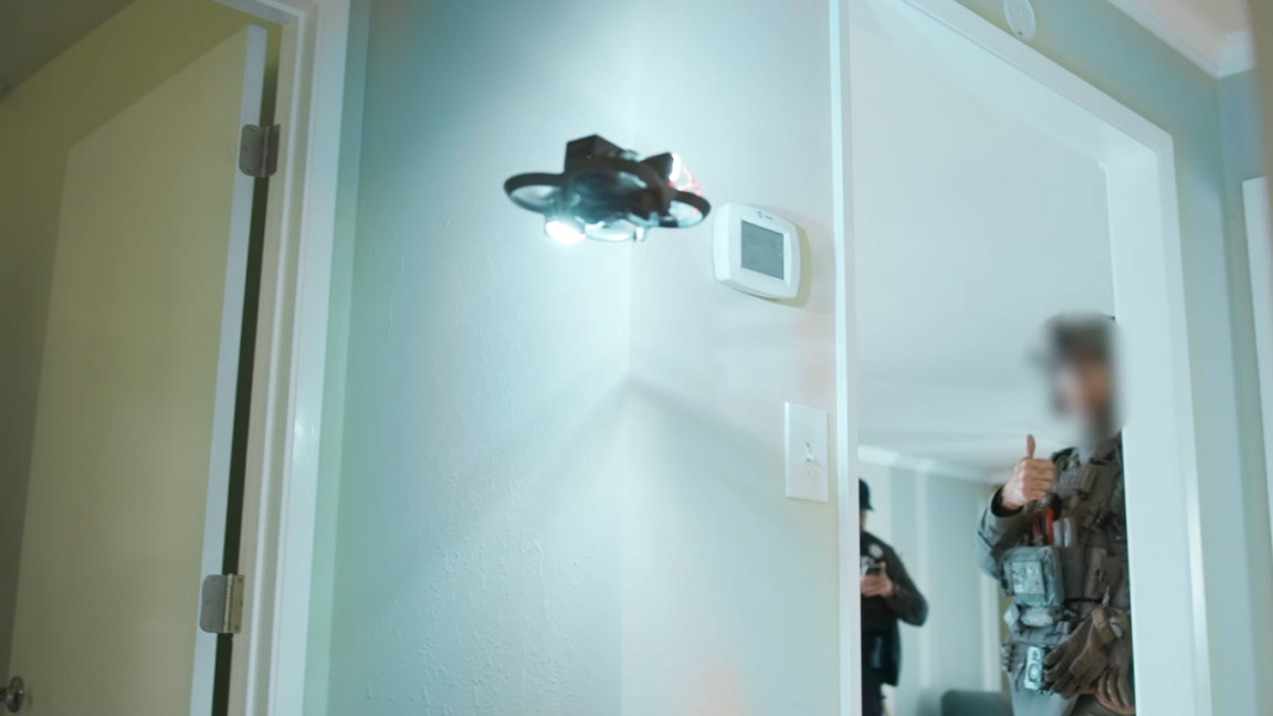 Source-feed image associated with Odd police video shows drone removing knife from motionless suspect