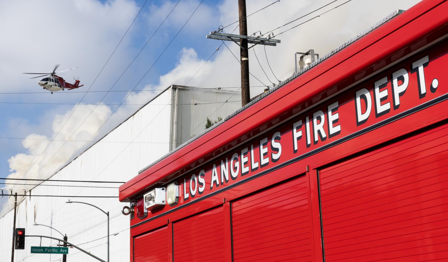 Source-feed image associated with L.A. declares state of emergency as Boyle Heights fire continues spewing smoke across region