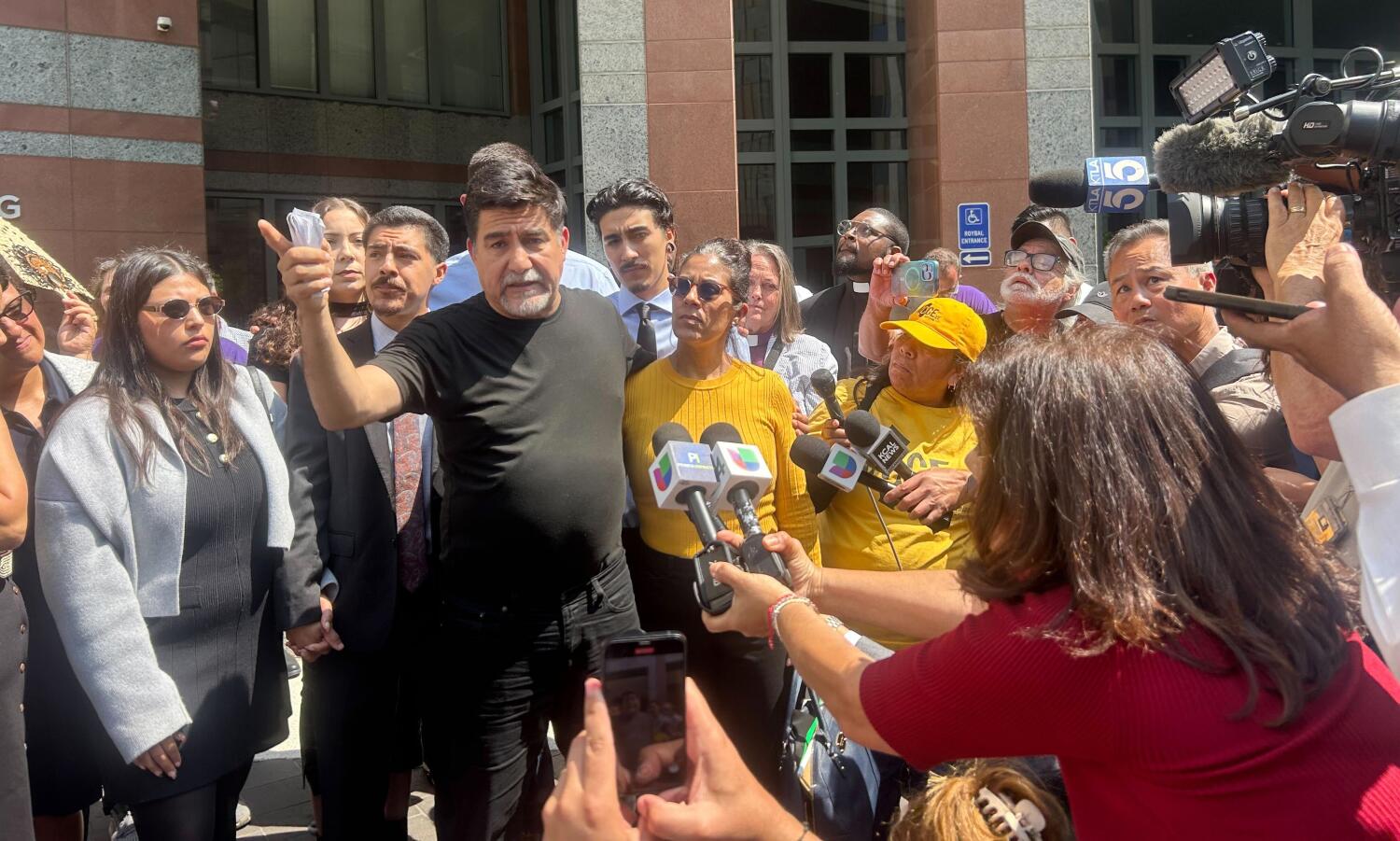 Source-feed image associated with Feds drop case against California labor leader arrested at immigration protest
