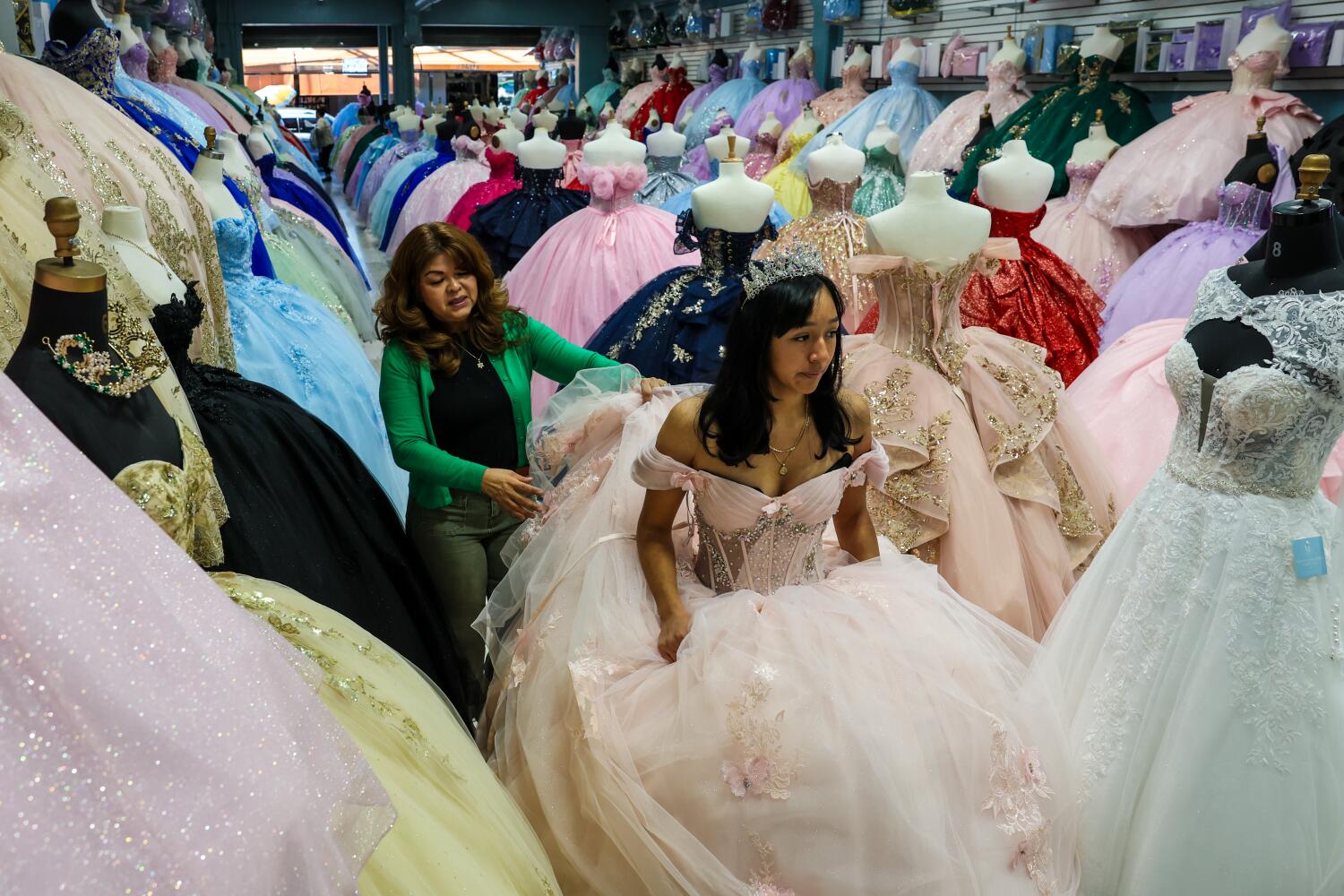 Source-feed image associated with 'We're in survival mode': A year after ICE raids, a couple fight to save their dress shops