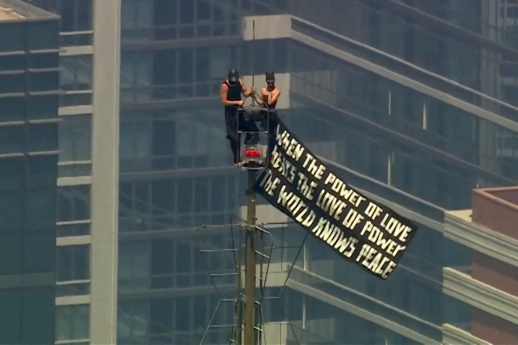 Source-feed image associated with 2 people arrested after unfurling banner atop the Empire State Building's antenna