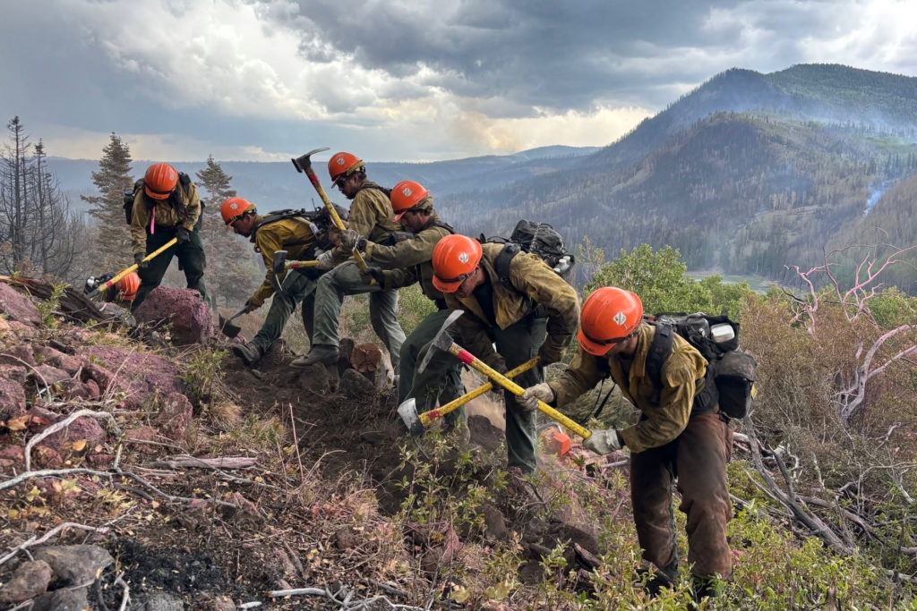 Source-feed image associated with Fast-moving fire in Utah, the largest in the U.S., spreads overnight, leading to more evacuations