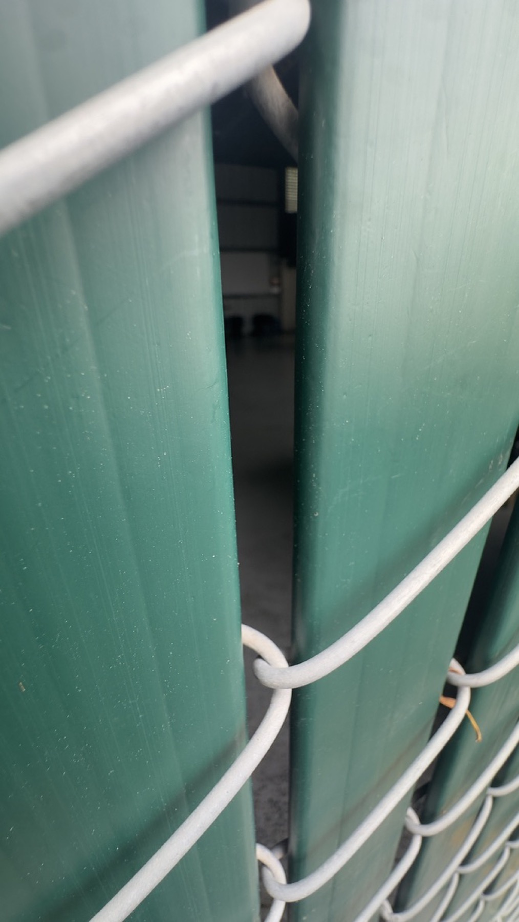 Close view through fencing toward an interior area at the Geng safe-parking site