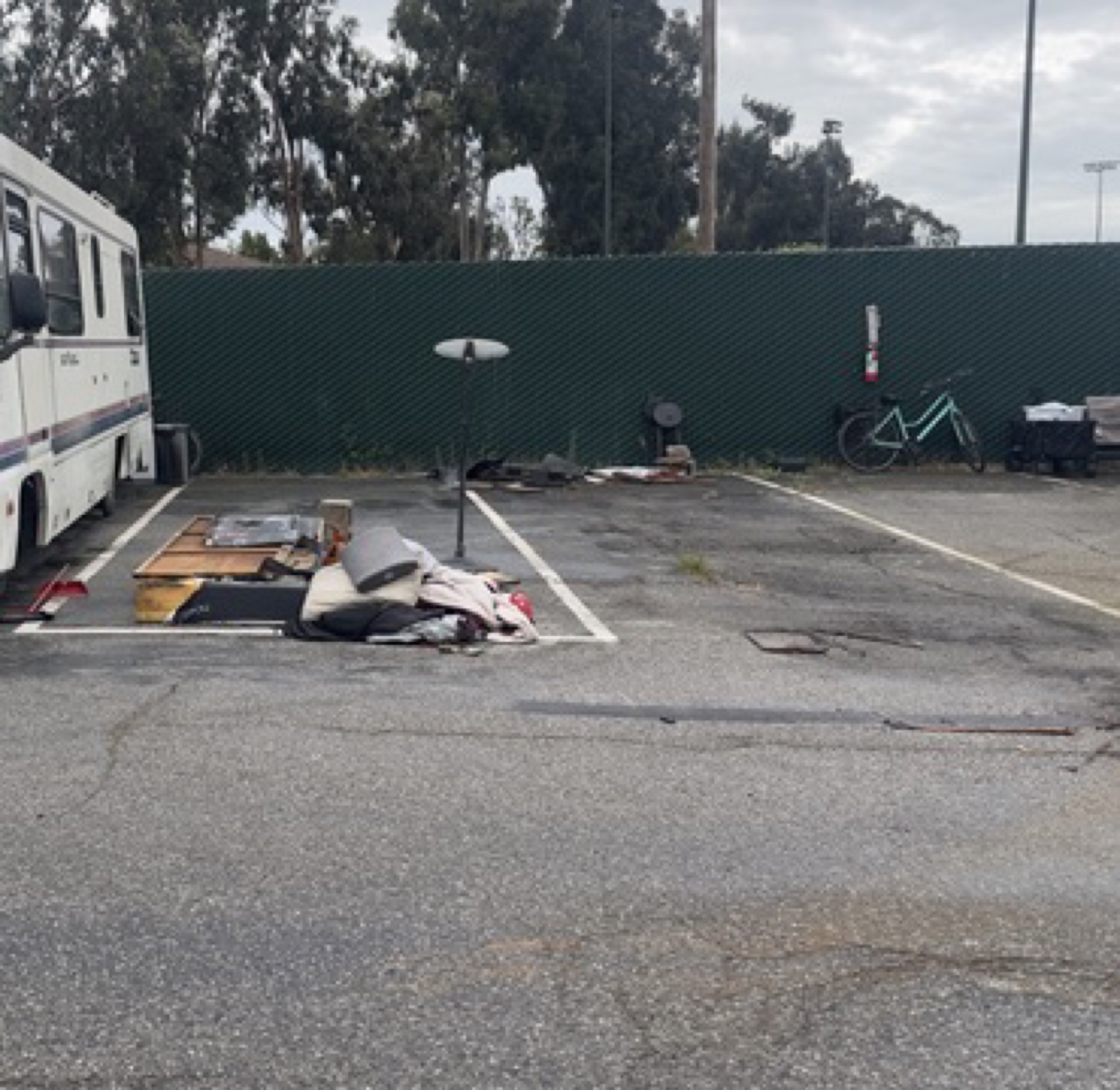 Debris near a parked RV at the Geng safe-parking site